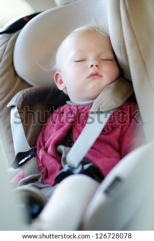Infant baby sleeping peacefully in a car seat