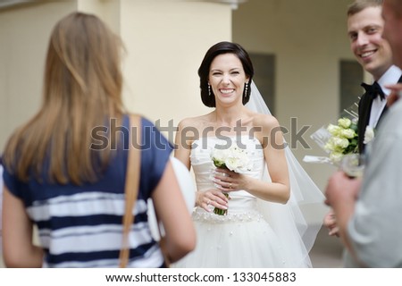 Wedding guests toasting happy bride and groom