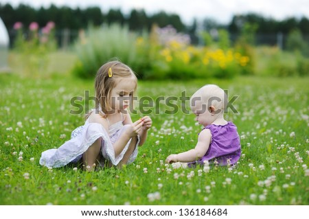 Two sisters playing outside on beautiful summer day
