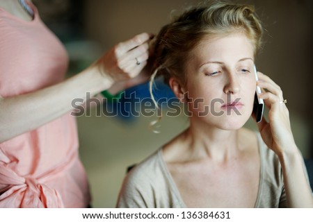 Young beautiful woman getting her hair done