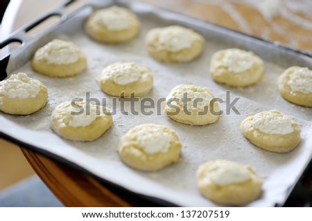 Ball dough with cottage cheese on top on the tray