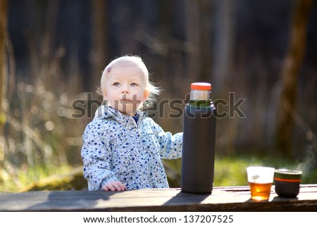 Adorable toddler girl camping in on spring