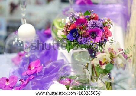 Beautiful purple flowers as a table decoration at wedding
