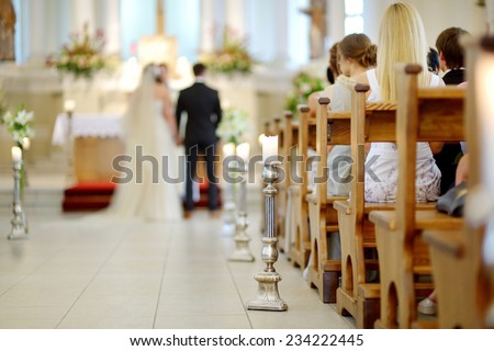 Beautiful candle wedding decoration in a church during wedding ceremony