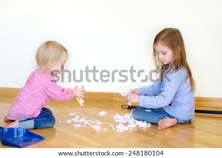 Two cute girls helping her mom to clean up at home