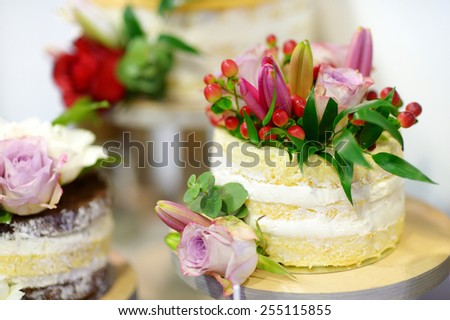 White wedding cake decorated with natural flowers