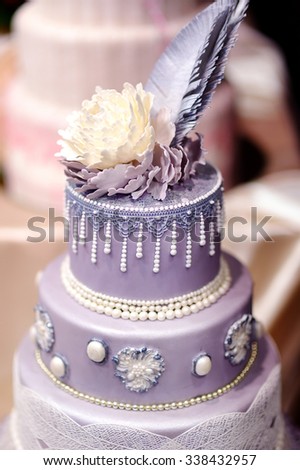 Purple wedding cake decorated with flowers and pearls