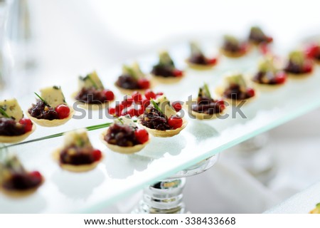 Plates with assorted finger food snacks on an event party or dinner