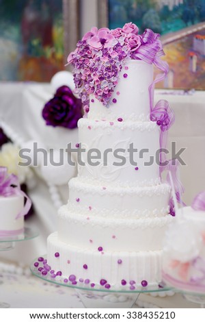 White wedding cake decorated with sugar purple bubbles