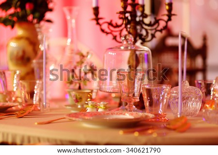 Table set for an event party or wedding reception in red light