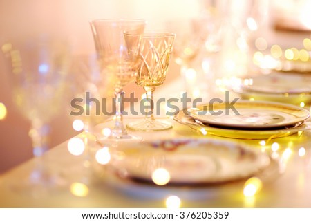 Table set for an event party or wedding reception in orange light