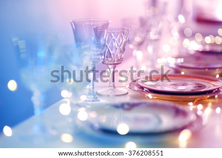 Table set for an event party or wedding reception in purple light