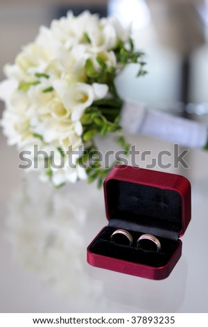 Wedding rings in the nice box and a wedding bouquet