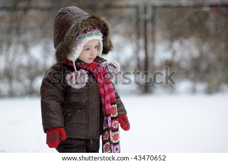 Little winter baby girl in brown jacket