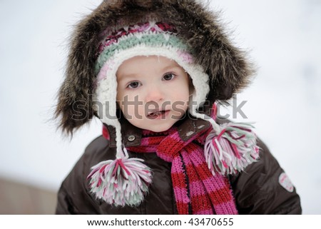 Little winter baby girl in brown jacket