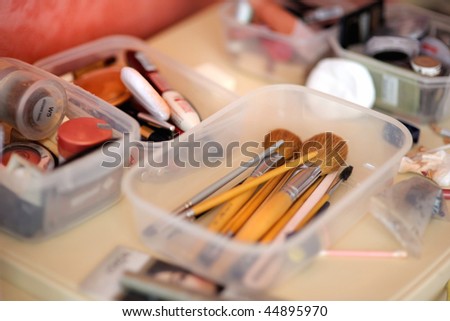 Some makeup brushes in a plastic box