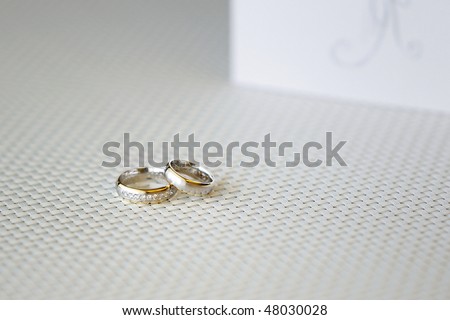 stock photo Two wedding rings and wedding invitation on a background
