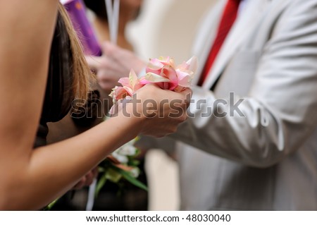 Women hang holding rose petals ready to throw