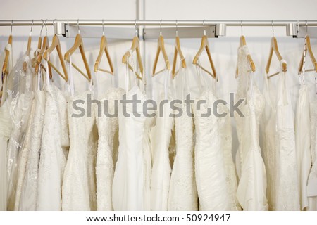 A few beautiful wedding dresses hanging on the stand