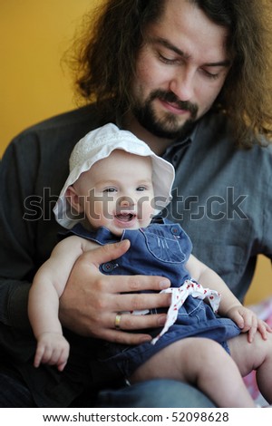 Three month old baby girl laughing in fathers hands
