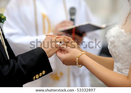 stock photo Bride putting a ring on groom 39s finger during wedding ceremony