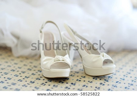 White elegant bridal shoes on the floor