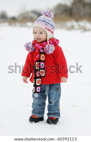 Little winter baby girl in red coat