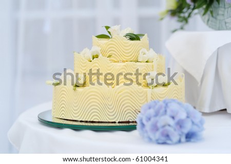 Fancy yellow wedding cake on a table