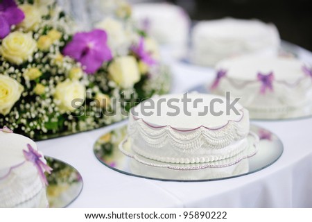 stock photo Delicious white and purple decorated wedding cake