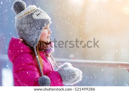 Funny little girl having fun in beautiful winter park