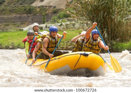 GROUP OF POWERFUL YOUNG MEN ON A RAFTING BOAT PATATE RIVER, ECUADOR
