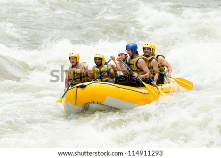 A group of men and women, with a guide, white water rafting on the Pastaza river, Ecuador