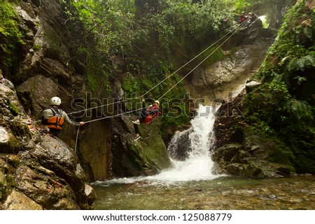 Improvized zipline during a canyoning tour in Ecuadorian rainforest Improvized zipline during a canyoning tour in Ecuadorian rainforest