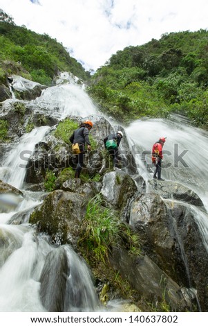 Canyoning adventure team in Chamana waterfall , Banos de Agua Santa Ecuador.