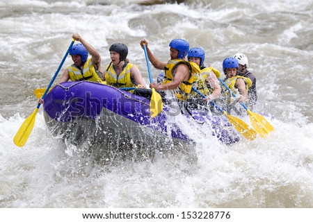 A group of men and women, with a guide, white water rafting on the Patate river, Ecuador