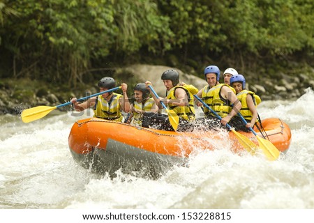 A group of men and women, with a guide, white water rafting on the Patate river, Ecuador