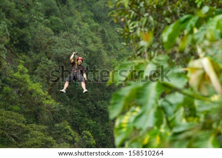 Adult man zip line adventure in Ecuadorian rainforest Adult man zip line adventure in Ecuadorian rainforest