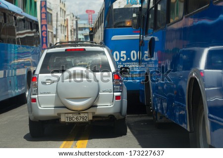 AMBATO, ECUADOR - JAN 24,2012: Aggressive driving , buses drivers not respecting priority rules on the streets of Ambato,Ecuador - January 24,2012