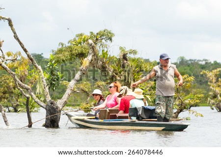 Tourists fishing legendary piranha fish in Ecuadorian Amazonian primary jungle