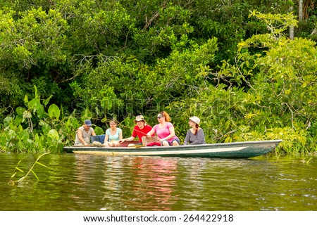 Tourists fishing legendary piranha fish in Ecuadorian Amazonian primary jungle