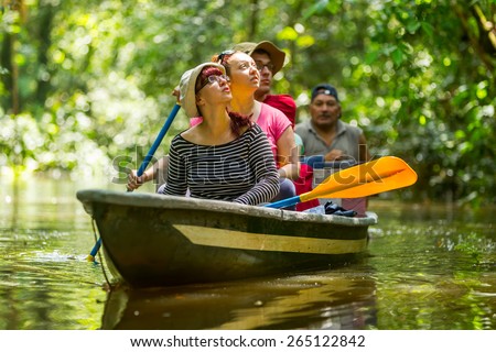 Tourist boat navigating on murky Amazonian water in Cuyabeno Wildlife Reserve
