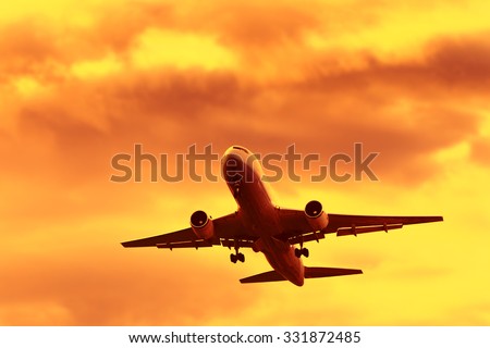 Jet Airplane In Flight At Sunset Time