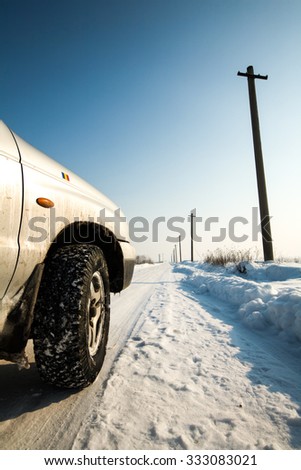 Winter Road Perspective With An Off Road Tire As Foreground