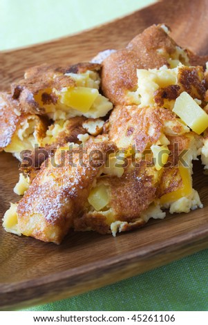Selective focus image of an omelette with mango fruits.