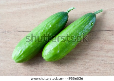 Selective image of small English cucumbers on a wooden countertop