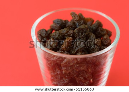 Selective focus image of raisins in a glass which are often in cereal products like muesli.