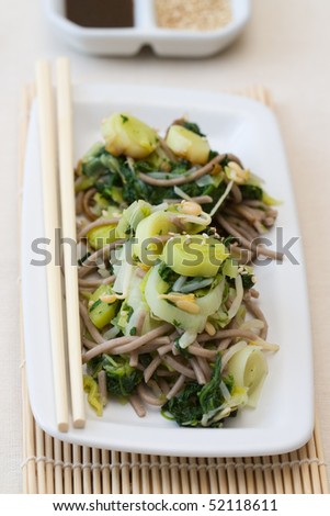 Japanese salad made from spinach, leek, soba noodle and sprouts, decorated with sesame.