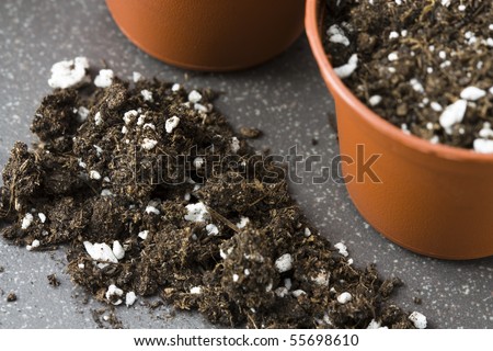 Still life with plant pots, potting soil and grains as symbol for gardening.