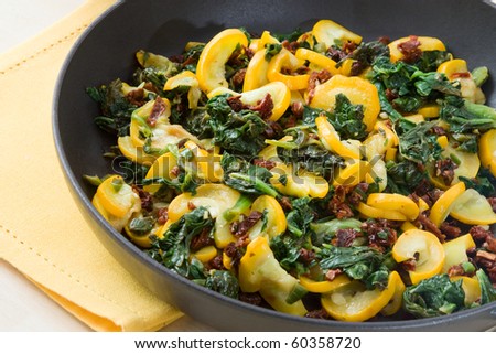Pan with fried zucchini and spinach.