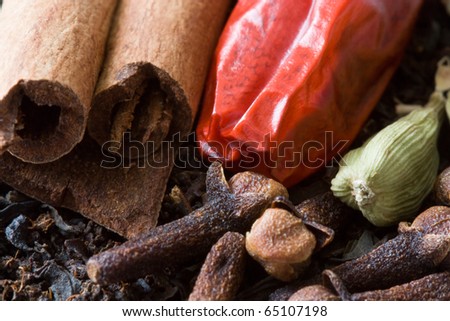 Decorative full frame image of cloves, cardamom, cinnamon and black tea, from which you can make Indian masala chai tea.